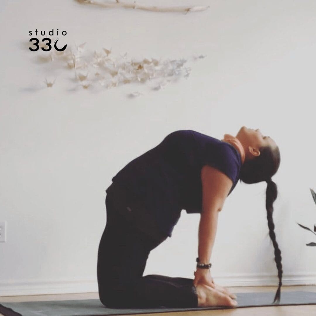 Amy doing Ustrasana (Camel Pose) with her braid touching the floor
